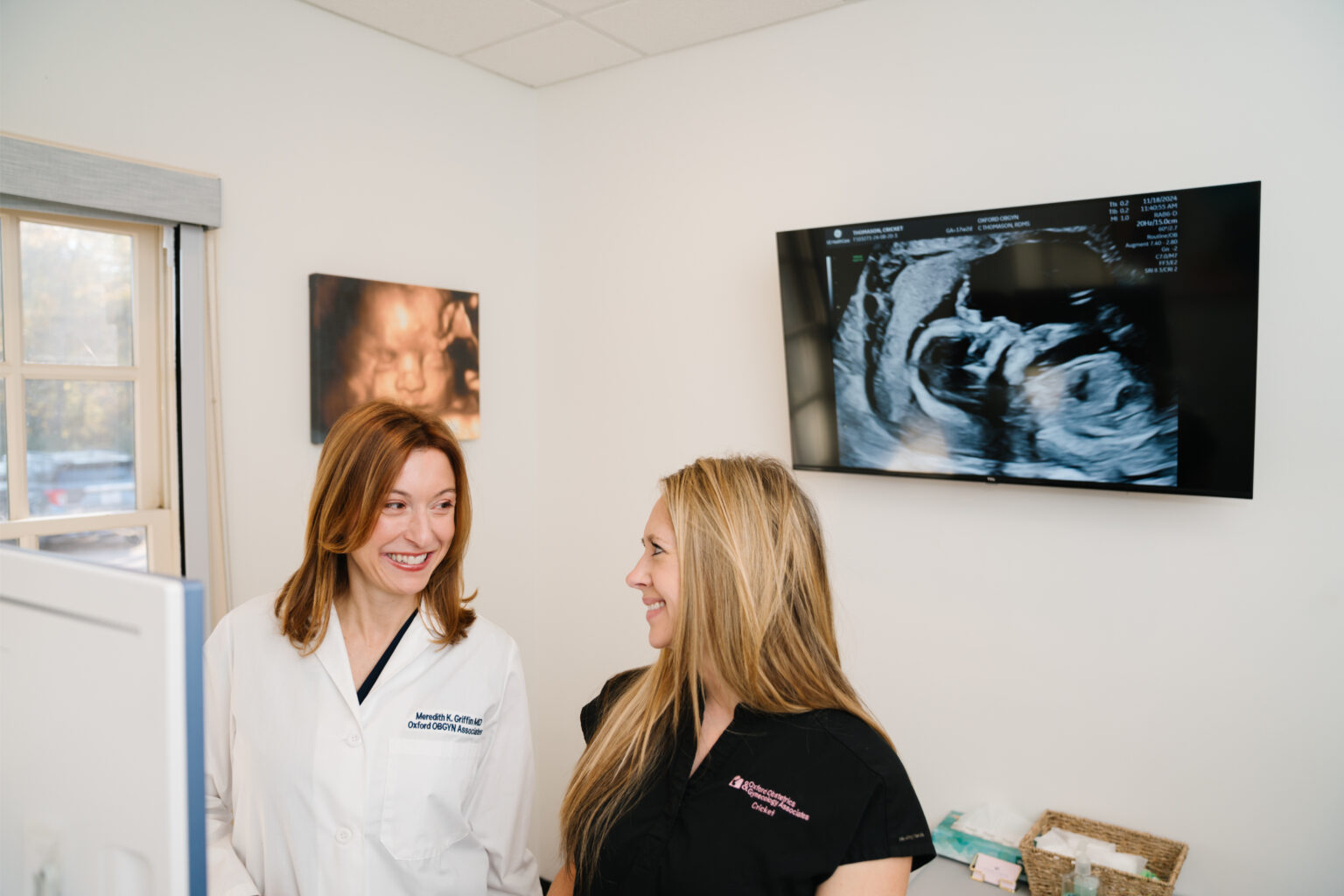 Two Oxford OBGYN team members in the practice's ultrasound room