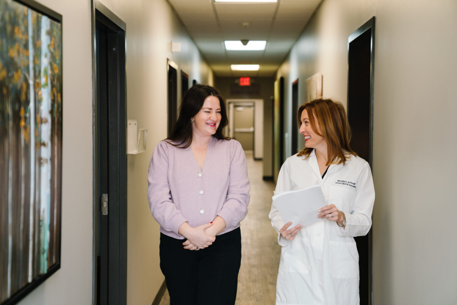 An Oxford OBGYN provider walking with a patient through the office